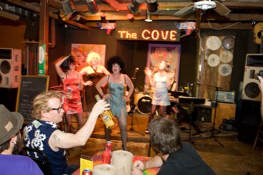 Ken Little Lifts the bottle.