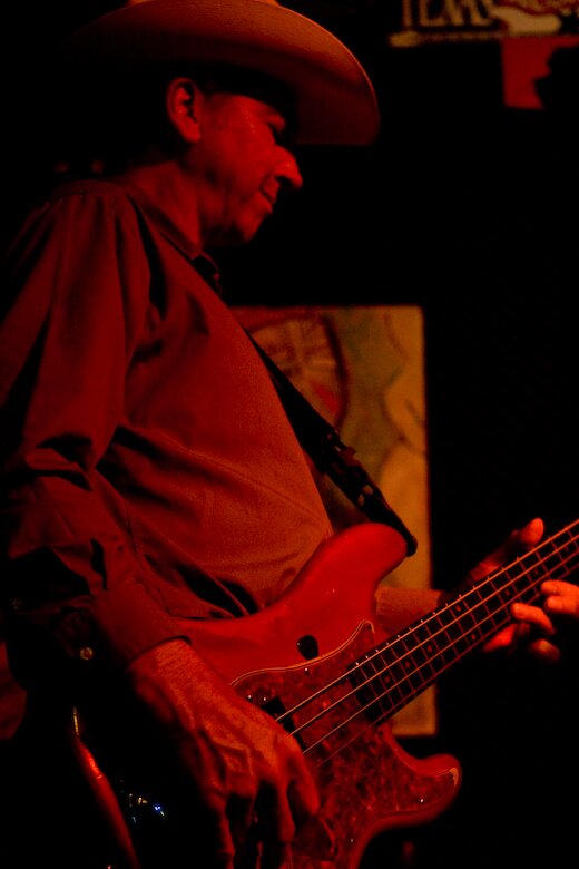 man in red playing guitar songs